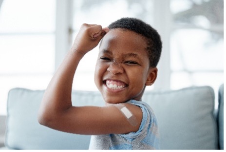 Little boy smiling with baindaid